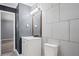 Bathroom with a white vanity, gray walls, white tile, and wood-look floors at 6997 Vesta Brook Dr, Morrow, GA 30260