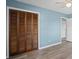 Bedroom featuring a closet, light blue walls, wood-look floors and white trim at 6997 Vesta Brook Dr, Morrow, GA 30260