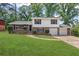 Charming two-story home with a brick and siding exterior, large front lawn, and two car garage at 6997 Vesta Brook Dr, Morrow, GA 30260