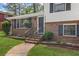 Inviting front entrance with brick facade, black shutters, and a well-manicured lawn at 6997 Vesta Brook Dr, Morrow, GA 30260