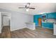 Open kitchen with hardwood floors, bright blue cabinets, and gray walls at 6997 Vesta Brook Dr, Morrow, GA 30260