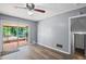 An open living room with hardwood floors, slider doors to back screened in porch, and gray walls at 6997 Vesta Brook Dr, Morrow, GA 30260