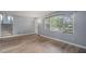 Bright living room featuring gray walls, hardwood floors, stairs to the second floor, and a large window at 6997 Vesta Brook Dr, Morrow, GA 30260