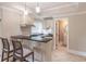 Basement bar with granite countertop, and white cabinets, adjacent to the bathroom at 1584 Water Springs Way, Dacula, GA 30019