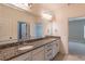 Bright bathroom features granite countertops, double sinks, large mirror, and white cabinetry at 1584 Water Springs Way, Dacula, GA 30019