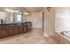 Spacious bathroom featuring double vanity, granite counters, and separate tub at 1584 Water Springs Way, Dacula, GA 30019