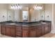 Luxurious bathroom featuring double sinks with granite countertops and large mirrors at 1584 Water Springs Way, Dacula, GA 30019