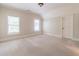 Neutral bedroom with two large windows, carpeting and a closet door at 1584 Water Springs Way, Dacula, GA 30019