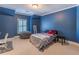 Blue bedroom offers plush carpet, a large bean bag chair, and a cozy bed with decorative pillows at 1584 Water Springs Way, Dacula, GA 30019