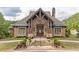 Community clubhouse featuring stone and brick, lush landscaping, and a stately entryway at 1584 Water Springs Way, Dacula, GA 30019