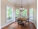 Sun-drenched dining room with large windows and a decorative chandelier at 1584 Water Springs Way, Dacula, GA 30019