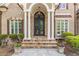 Elegant front entrance with stone steps, columns, and a wrought-iron double door at 1584 Water Springs Way, Dacula, GA 30019
