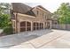 Lovely brick home featuring a three-car garage and concrete driveway at 1584 Water Springs Way, Dacula, GA 30019