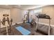Fully equipped home gym with a treadmill, weight machines, and exercise equipment at 1584 Water Springs Way, Dacula, GA 30019
