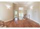 Bright landing with hardwood floors, sconce lighting, and an open staircase at 1584 Water Springs Way, Dacula, GA 30019