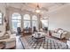 Bright living room with coffered ceilings, large windows, and comfortable seating at 1584 Water Springs Way, Dacula, GA 30019