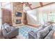 Inviting living room features a stone fireplace, built-in bookshelves, and hardwood floors at 1584 Water Springs Way, Dacula, GA 30019