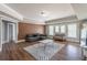 Stylish living room boasts hardwood floors, neutral paint, modern furniture, and a geometric rug at 1584 Water Springs Way, Dacula, GA 30019