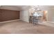 Spacious living room featuring a bar area, plush carpeting, and ample closet space at 1584 Water Springs Way, Dacula, GA 30019