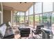 Enclosed sunroom with comfortable seating and panoramic views of the surrounding landscape at 1584 Water Springs Way, Dacula, GA 30019