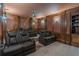 Opulent home theater with comfortable leather seating, tiered platforms, and custom wood trim at 1584 Water Springs Way, Dacula, GA 30019