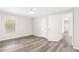 Bright bedroom featuring gray flooring, a window, a fan, and access to a closet and other rooms at 204 Countryside Se Pl # 204, Smyrna, GA 30080