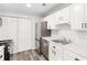 Kitchen with white cabinets, stainless steel appliances, vinyl floors, and a pantry at 204 Countryside Se Pl # 204, Smyrna, GA 30080