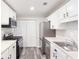Bright kitchen with white cabinetry, stainless steel appliances, and modern flooring at 204 Countryside Se Pl # 204, Smyrna, GA 30080