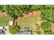 Aerial view of large backyard featuring mature trees, a wooden fence, and well-maintained lawn at 40 Polo Xing, Hiram, GA 30141