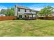 Large backyard, showcasing the expansive lawn, mature trees, wooden fence and covered back deck at 40 Polo Xing, Hiram, GA 30141