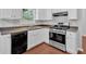 Corner kitchen with stainless steel appliances, white cabinets, and a window view at 40 Polo Xing, Hiram, GA 30141