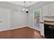 Kitchen nook with white cabinets, hardwood flooring, and outside access at 40 Polo Xing, Hiram, GA 30141