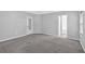 Spacious main bedroom with neutral carpet, an ensuite bathroom, and a window letting in natural light at 40 Polo Xing, Hiram, GA 30141