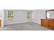 Main bedroom with neutral carpet, natural light from two windows, and a wooden dresser at 40 Polo Xing, Hiram, GA 30141