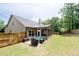 Backyard featuring well manicured landscaping and a screened in porch at 4690 Hopewell Manor Dr, Cumming, GA 30028