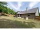 A well-manicured backyard with a lush green lawn, screened-in porch, and wooden perimeter fence at 4690 Hopewell Manor Dr, Cumming, GA 30028