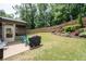 Backyard featuring well manicured landscaping, a grill, and a screened in porch at 4690 Hopewell Manor Dr, Cumming, GA 30028