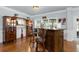 Custom bar area with rich wood cabinets, hardwood floors and view to the backyard at 4690 Hopewell Manor Dr, Cumming, GA 30028