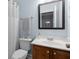 Bathroom featuring a vanity with dark wood cabinets, white sink, and framed mirror at 4690 Hopewell Manor Dr, Cumming, GA 30028