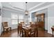 Dining room with hardwood floors, crown molding, and elegant wainscoting at 4690 Hopewell Manor Dr, Cumming, GA 30028