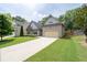 Charming two-story home with an attached two-car garage, showcasing the driveway and lawn at 4690 Hopewell Manor Dr, Cumming, GA 30028