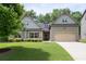 Charming two-story home featuring a well-manicured lawn and an attached two-car garage at 4690 Hopewell Manor Dr, Cumming, GA 30028