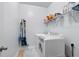 Laundry room featuring a white washer and dryer with storage shelf at 4690 Hopewell Manor Dr, Cumming, GA 30028