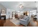 Open-concept living area with fireplace, hardwood floors, and a view into the kitchen and dining area at 4690 Hopewell Manor Dr, Cumming, GA 30028