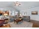 Open living area showcasing hardwood floors, comfortable seating, and seamless flow to kitchen at 4690 Hopewell Manor Dr, Cumming, GA 30028