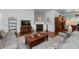 Spacious living room with hardwood floors, fireplace, large windows, and comfortable seating arrangement at 4690 Hopewell Manor Dr, Cumming, GA 30028