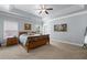 Main bedroom featuring an elegant tray ceiling, neutral colors, and hardwood floors at 4690 Hopewell Manor Dr, Cumming, GA 30028