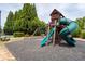 Community playground with a slide, swing set, and play structure for children at 4690 Hopewell Manor Dr, Cumming, GA 30028