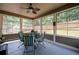 Comfortable screened in porch with seating and ceiling fan at 4690 Hopewell Manor Dr, Cumming, GA 30028
