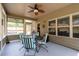 Comfortable screened in porch with seating and ceiling fan at 4690 Hopewell Manor Dr, Cumming, GA 30028
